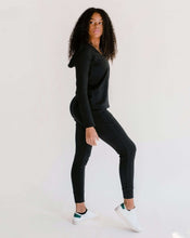 Load image into Gallery viewer, Photo of a woman wearing amrêve organic pima cotton joggers and hoodie in black.
